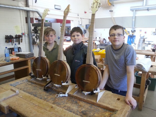 Scott Nicoll, Daniel Gough and Robbie Ferguson with their completed banjos.